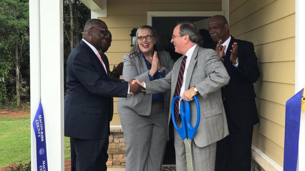 Macon-Bibb County Mayor Robert Reichert (right) shakes hands Wednesday with Rufus Washington, director of the US Department of Housing and Urban Development, while Shannon Gordon (center), River Edge’s chief executive officer executive, and Michael Link, Georgia Department of Behavioral Health and Developmental Disabilities, look on. Officials welcomed Wednesday the latest River Edge housing development: Bayside Village.