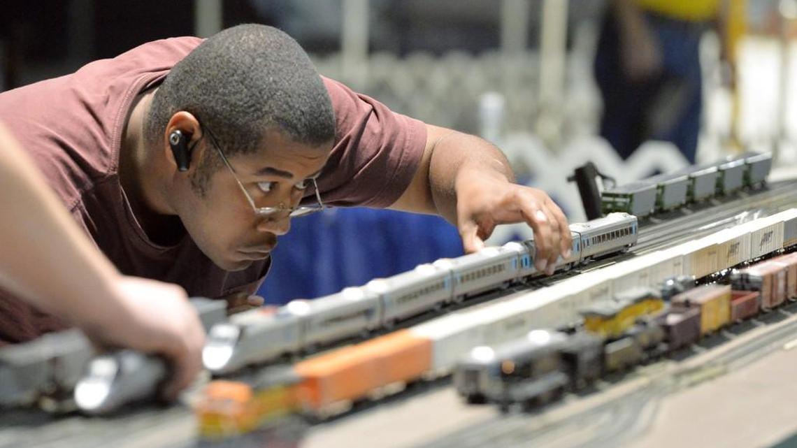 A member of the Middle Georgia Model Railroad Club puts together his bullet train during a Planes and Trains exhibit in 2013 at the Museum of Aviation.