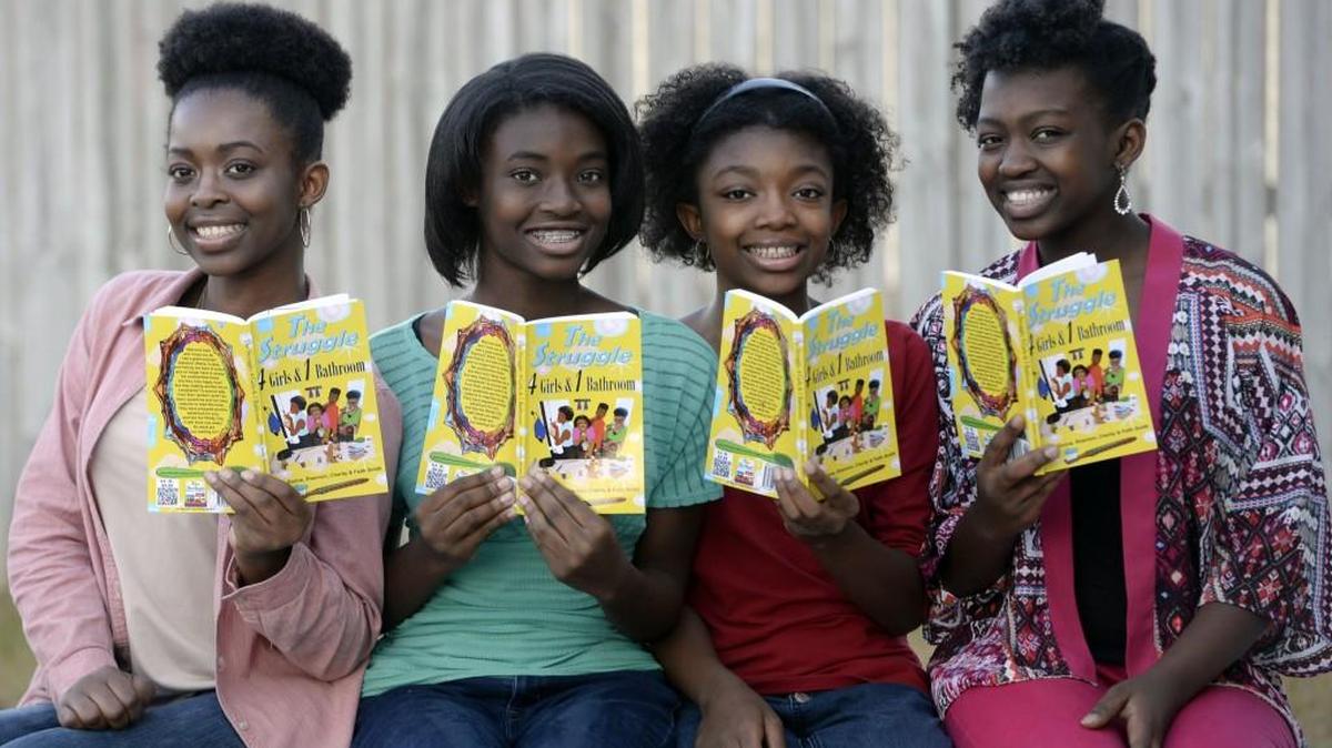 Donna, Charity, Faith, and Shannon Smith, at their Warner Robins home, hold the second book they authored.
