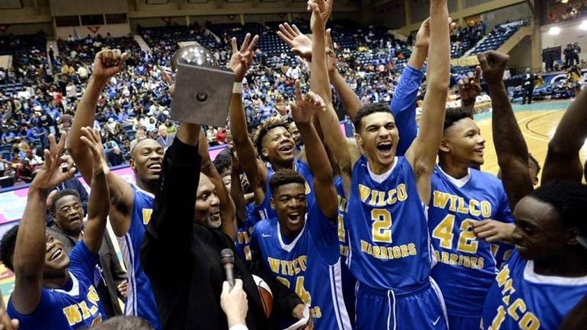 Wilkinson County High’s boys basketball team celebrates its 2016 GHSA championship.