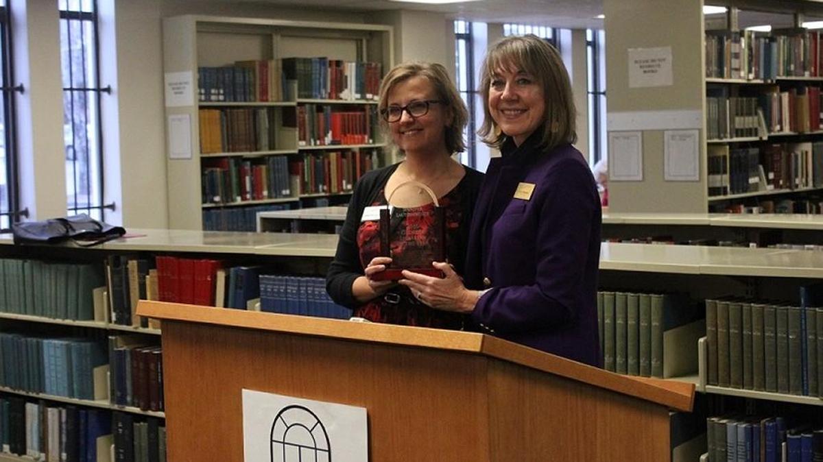 State Librarian Julie Walker, right, presents Jennifer Lautzenheiser with Georgia's Public Librarian of the Year award on Jan. 12, 2017 at Washinton Memorial Library.