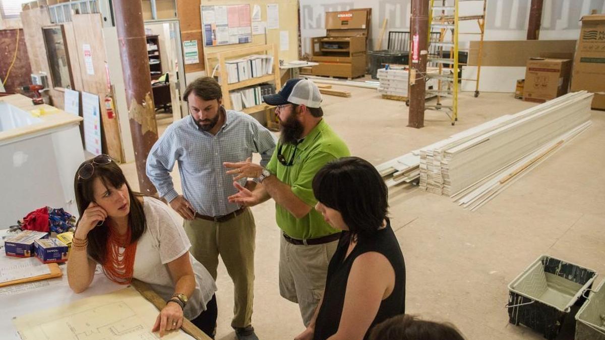 From left, business partners Trish Whitley, Richie Jones and Brian Whitley go over the plans for their brewpub Piedmont Brewery and Kitchen with designers Michelle Garlington, right, and Carrie Robinson, second from right.