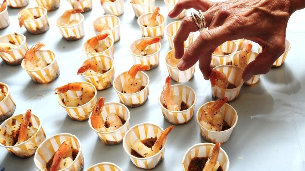 Jodi Palmer of Macon Magazine arranges samples of Caribbean shrimp with pesto at the Tubman Museum's Taste of Soul event on June 22, 2014.