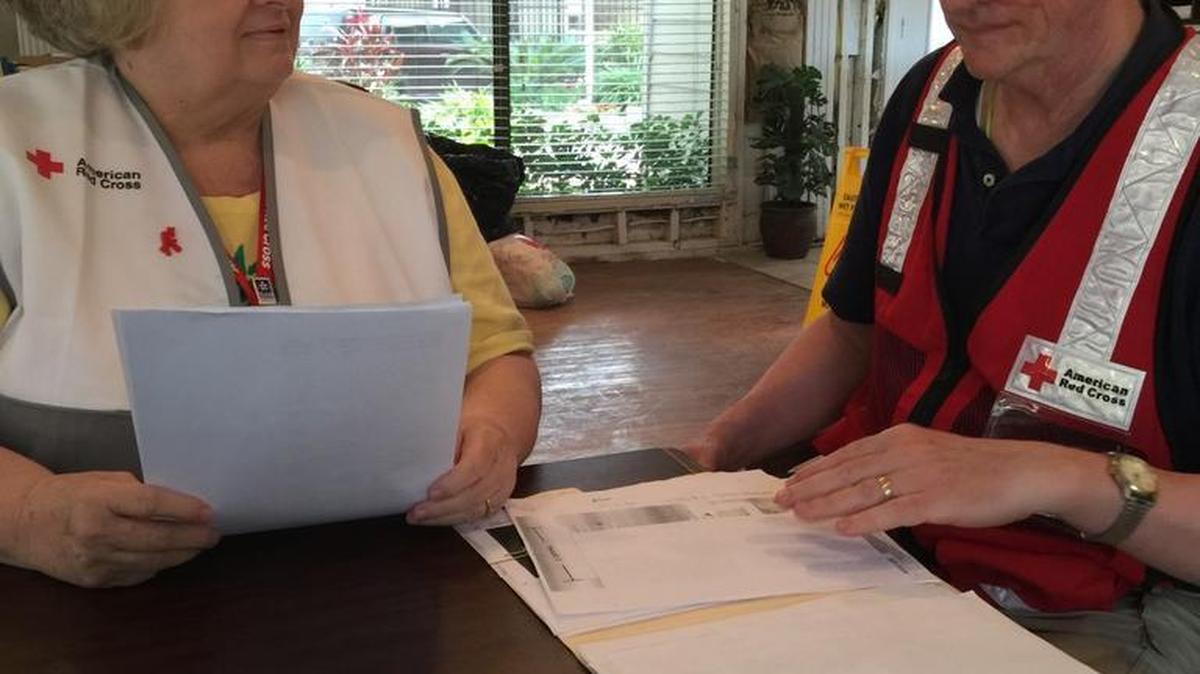 Linda DeVane, left, is shown volunteering, helping people affected by floods in Texas.