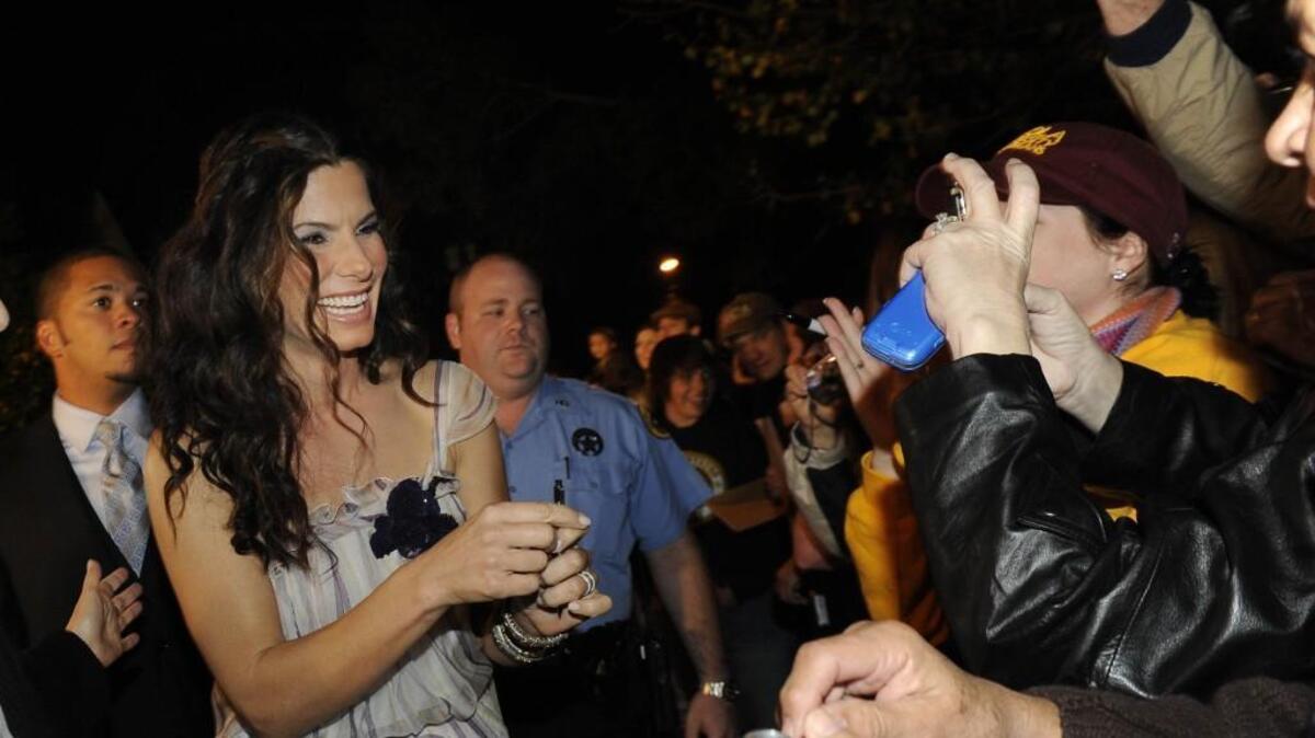 Sandra Bullock greets fans while at a red carpet premiere of her film, "The Blind Side," in New Orleans in 2009.