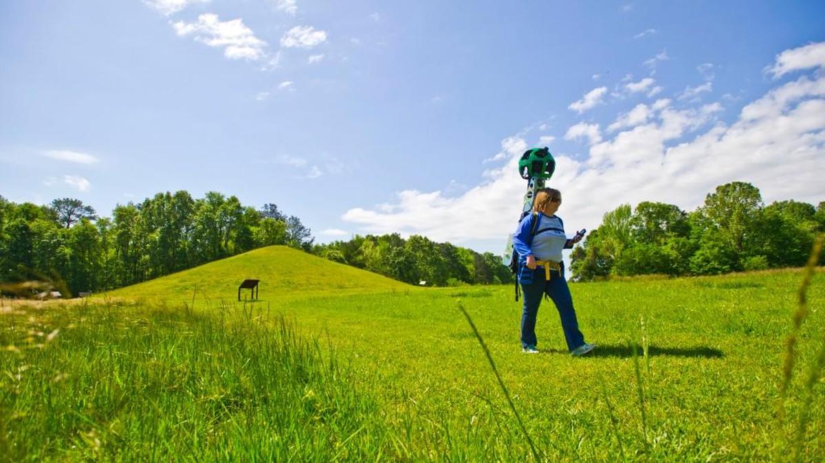 Lisa Lemon with Ocmulgee National Monument Association walks from the Earth Lodge to the Cornfield Mound with the 45 pound Google Tracker.