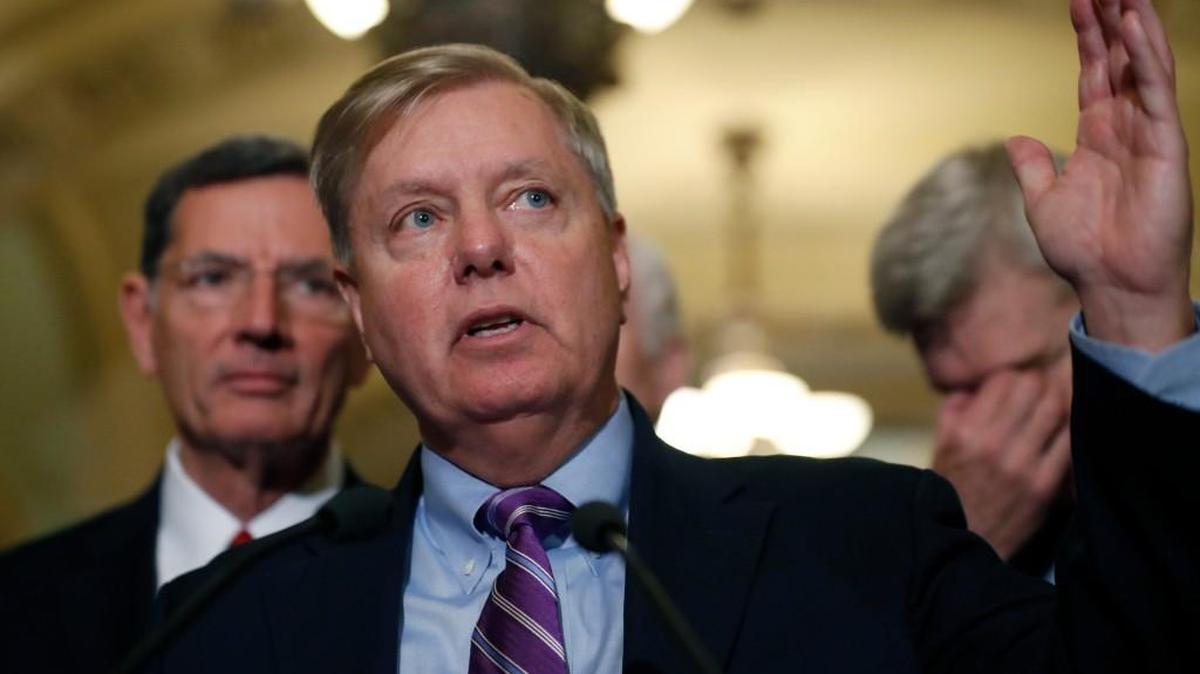 Sen. Lindsey Graham, R-S.C., center, speaks, accompanied by Sen. John Barrasso, R-Wyo., left, and Sen. Bill Cassidy, R-La., on Capitol Hill, Tuesday in Washington.