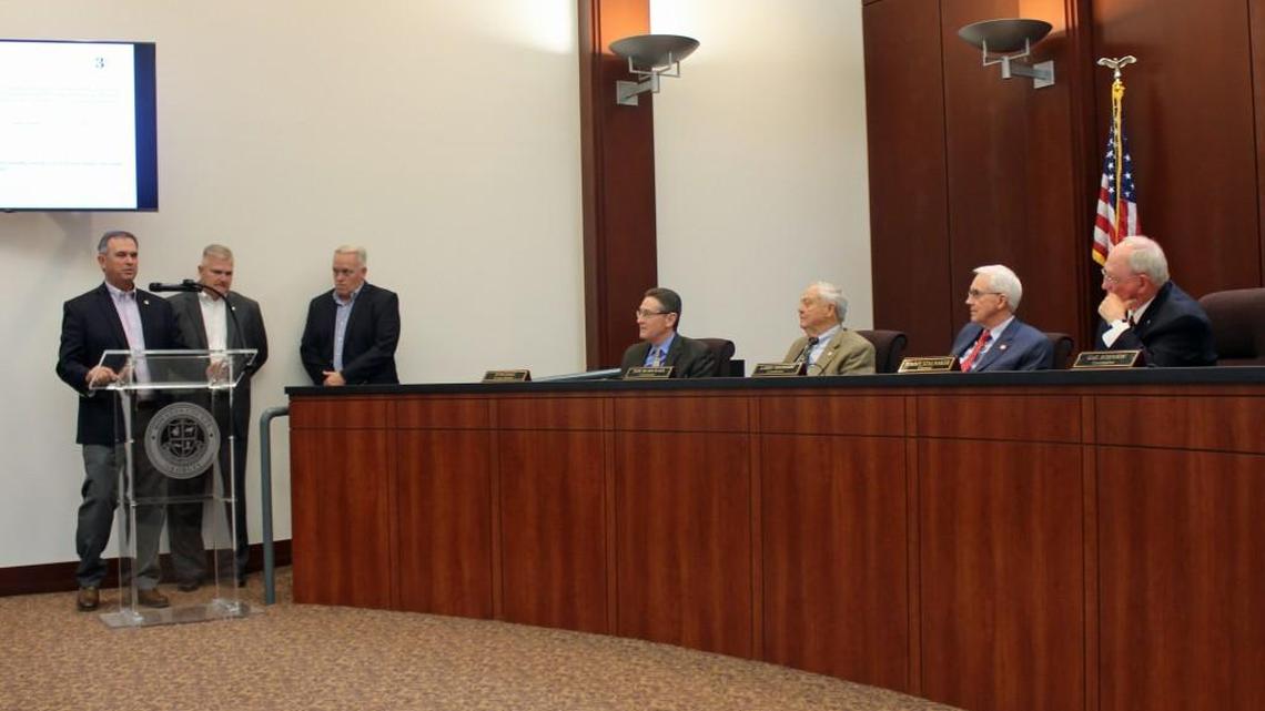 Warner Robins Mayor Randy Toms speaks to the Houston County Commission on Tuesday along with council members Tim Thomas, center, and Keith Lauritsen about an agreement on a proposed shopping center.