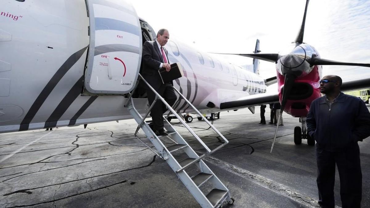 Mayor Robert Reichert walks down the steps of a Silver Airways plane at the Middle Georgia Regional Airport in this 2013 file photo. A new company — Contour Airlines — is on track to offer flights from Macon to Washington, D.C. starting late this spring.