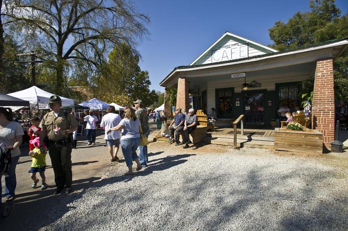 People wander the street at the Whistle Stop Cafe at the 2016 Green Tomato Festival in Juliette Saturday, Oct. 29, 2016.