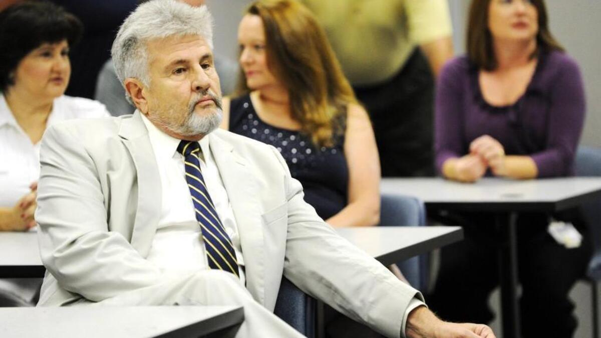 Surveyor Terry Scarborough waits for a news conference to begin at the Secretary of State’s office in Macon on Aug. 23, 2011.