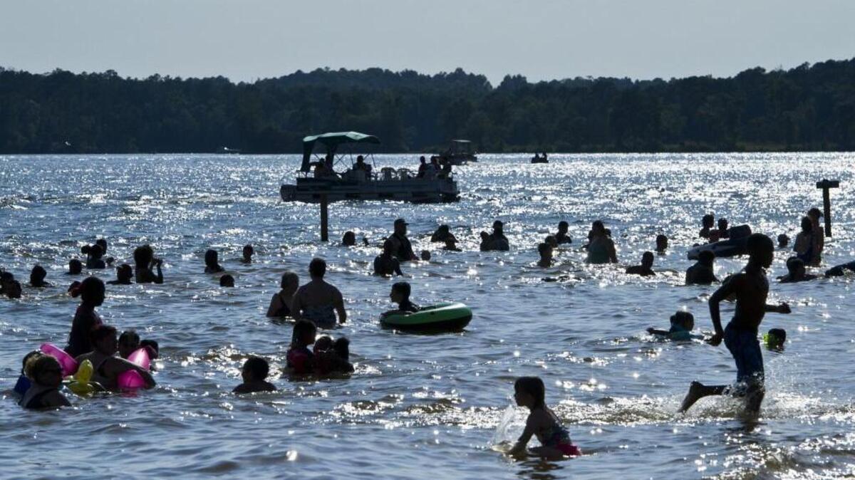 Swimmers enjoy the water at the Sparks Over the Park Independence Day Celebration at Lake Tobesofkee in 2016.