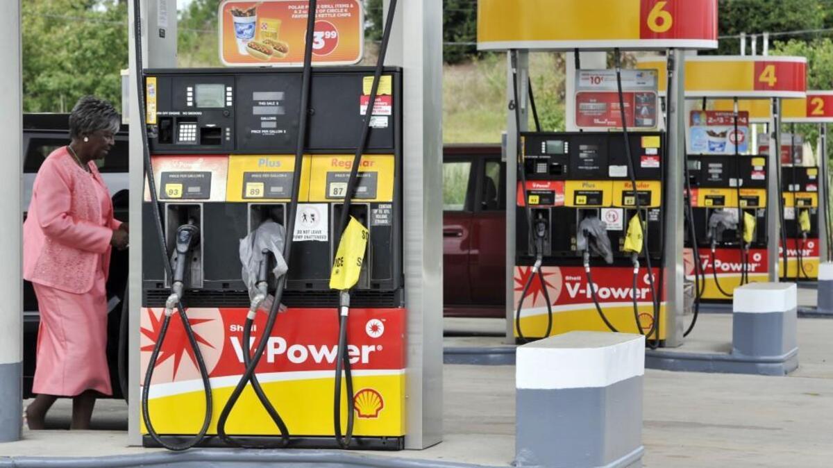 Lillie Stewart, left, prepares to buy premium gas at the Circle K store on U.S. 80 in west Bibb County where bags over regular and mid-grade gas showed the shortage in supply as the result of a recent pipeline spill in Alabama.