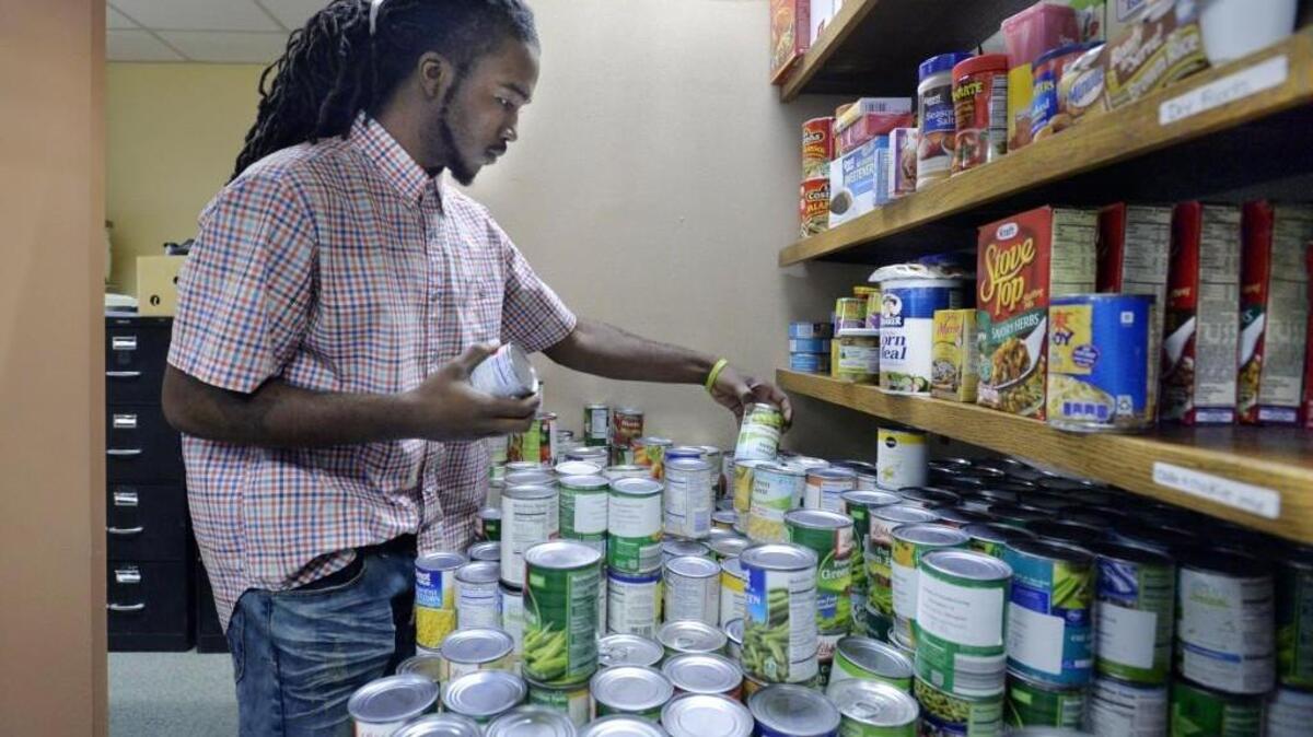 Johnathan Chatman, who is trying to support himself, his mother and 12 siblings, also volunteers at the Mentors Project where he sorts canned goods for the needy.