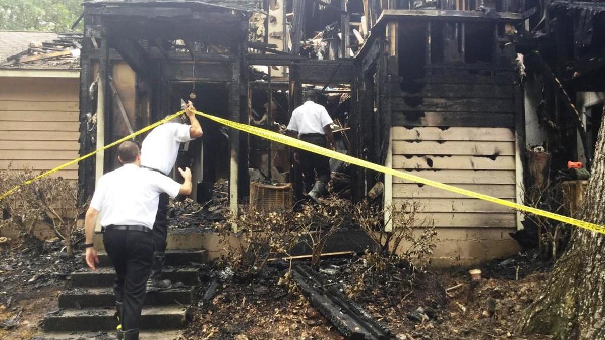 Warner Robins fire investigators on site Tuesday after a fire ripped through a Wellston Ridge apartment building the previous night.