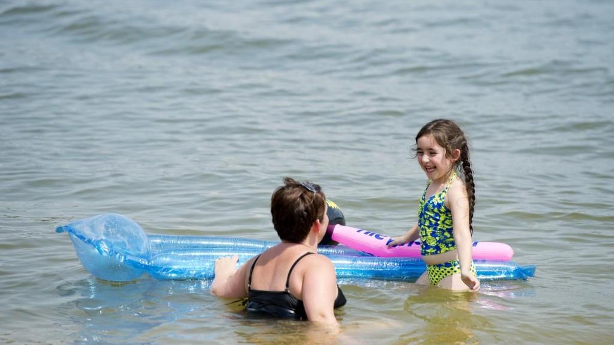 Madison Pritchard, 5, cools off at Lake Tobesofkee's Claystone Park with her mother, Stacy, on Sunday afternoon.