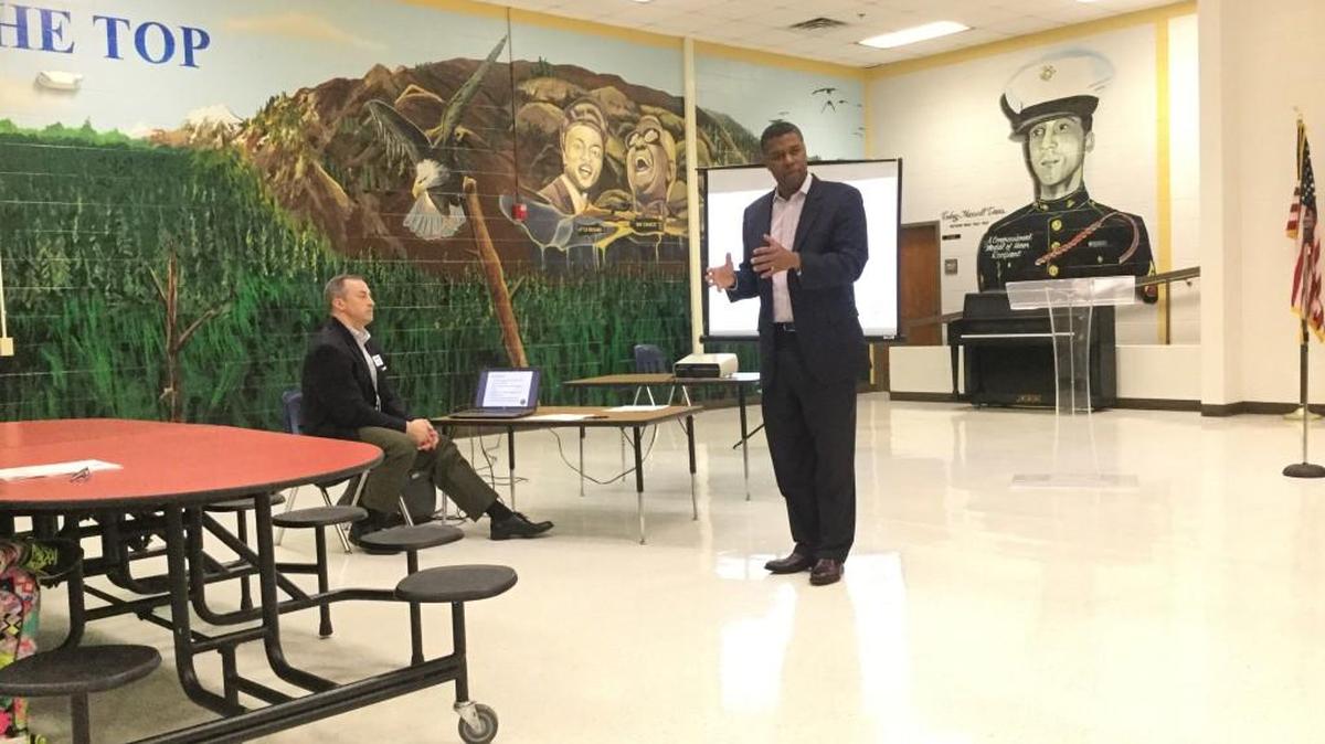 Rep. James Beverly addresses a crowd of nearly 100 people in the cafeteria of L.H. Williams at a town hall meeting Monday night.