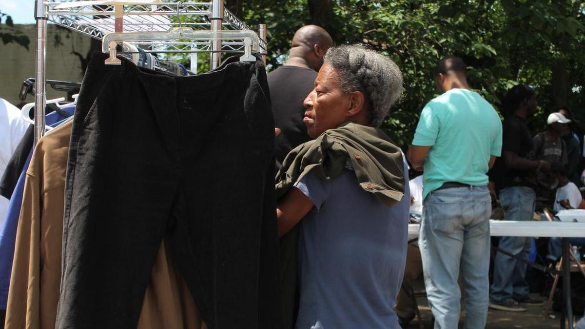 Peggy Williams, 64, picks out a blue jean jacket at the 10th annual Dr. D.T. Walton Memorial Cookout and Health Fair on Friday afternoon in Macon.