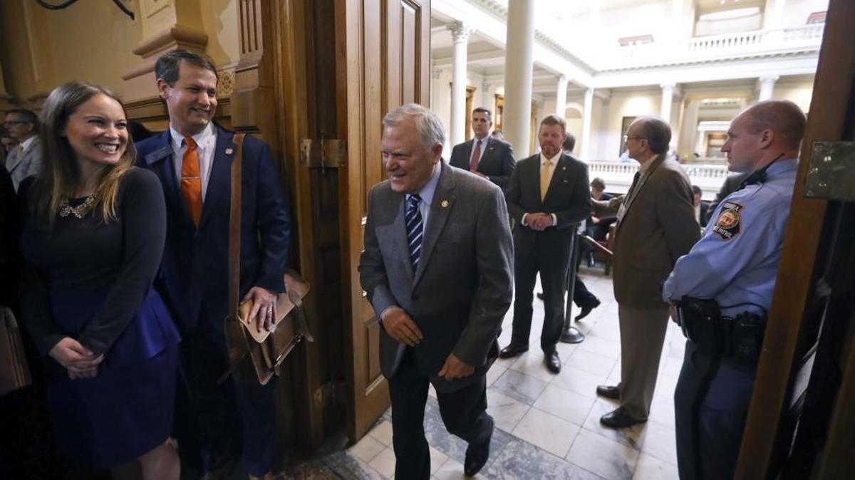Georgia Gov. Nathan Deal enters a statehouse room to applause as he makes his way to the podium to address House and Senate budget hearings on Tuesday. Deal is proposing some $66 million in new spending for child welfare.
