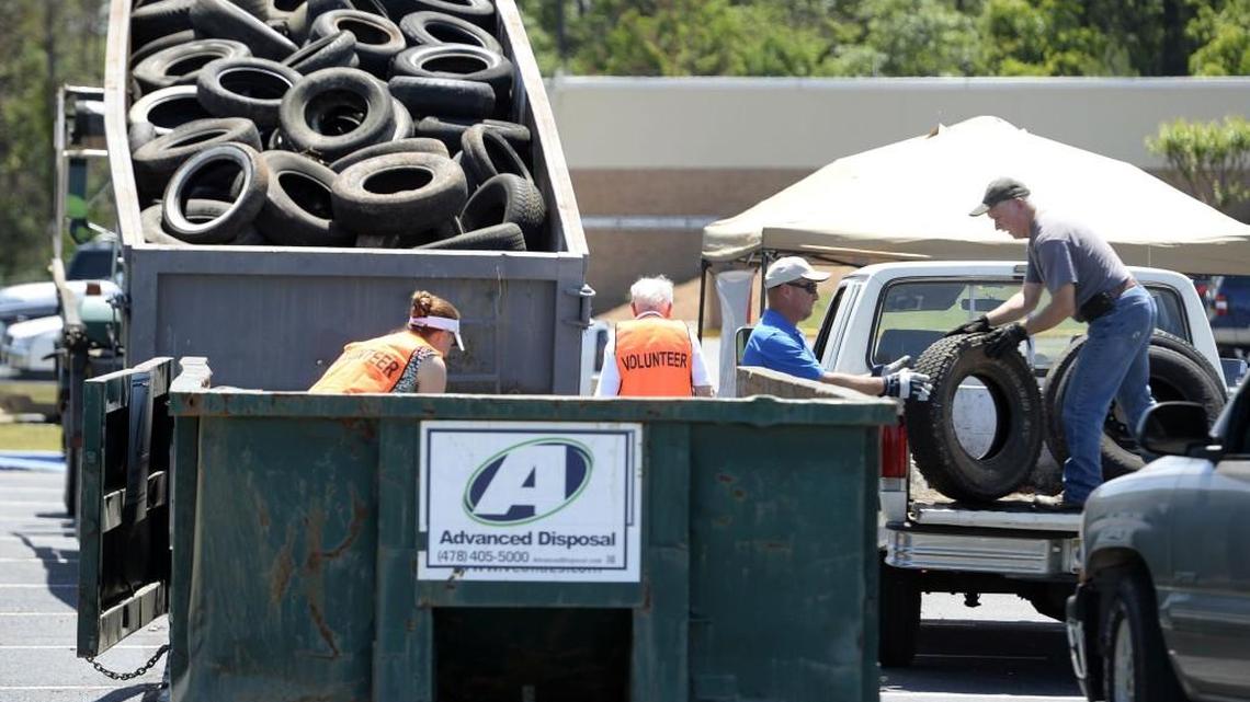 Keep Warner Robins Beautiful volunteers unload old tires at the county annex where many people brought old tires during an amnesty day April 20.