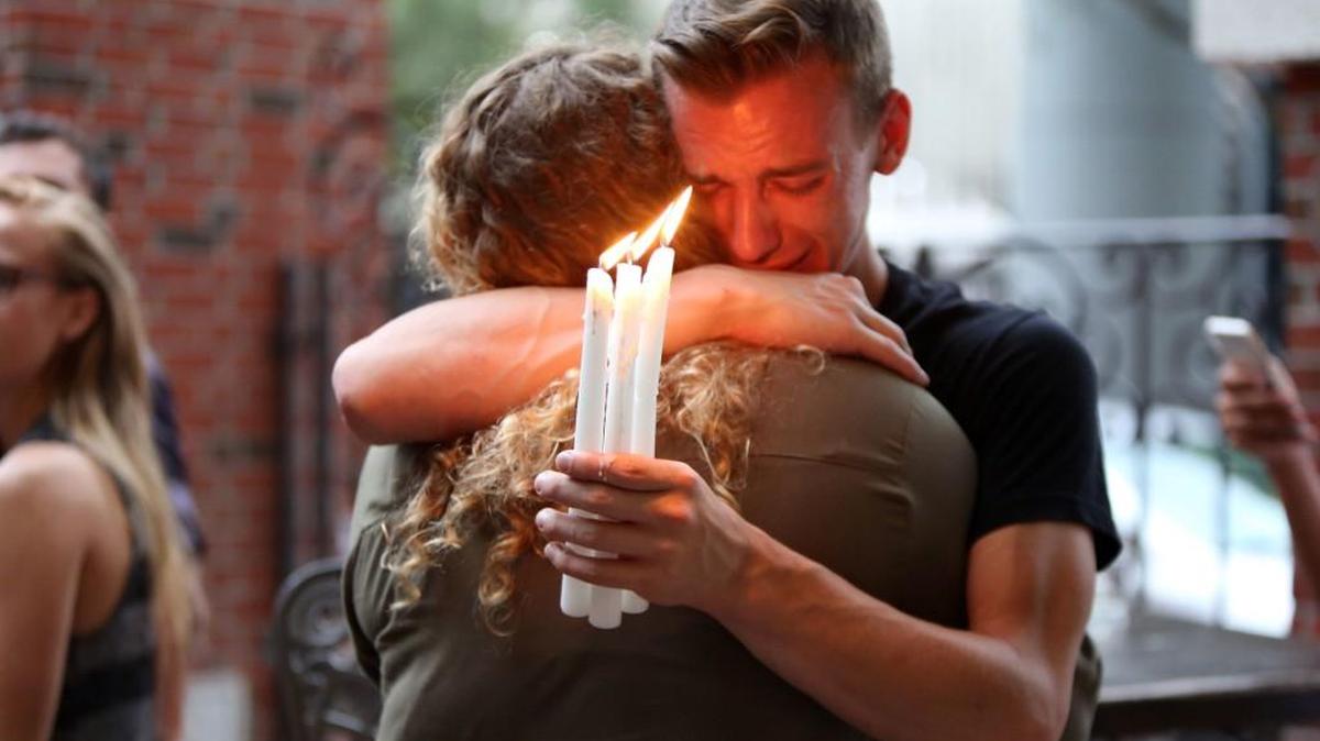 In this June 12 file photo, Brett Morian hugs an fellow mourner during a candlelight vigil for those killed at the Pulse nightclub in Orlando, Florida. The worst mass shooting in modern U.S. history unfolded on Latin Night at the gay nightclub. The gunman, Omar Mateen, killed 49 people over the course of three hours before dying in a shootout with SWAT team members. During the standoff, he pledged allegiance to the Islamic State.