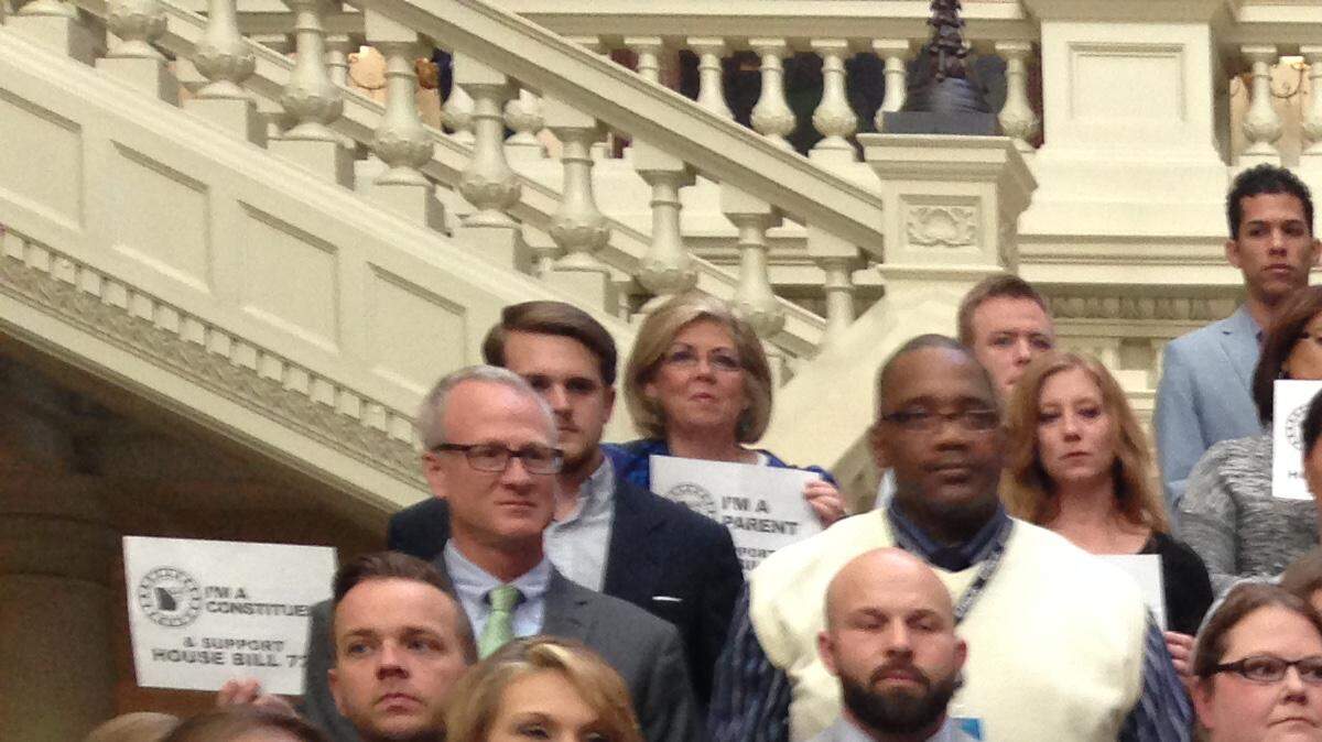 State Rep. Allen Peake, R-Macon, stands with supporters at the state Capitol on Feb. 16.