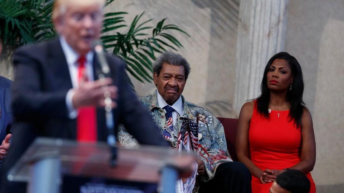 Omarosa Manigault, right, and boxing promoter Don King, center, listen as Republican presidential candidate Donald Trump speaks to the Pastors Leadership Conference at New Spirit Revival Center, Wednesday, Sept. 21, 2016, in Cleveland, Ohio.