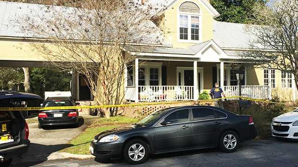 An FBI agent is seen walking into the Statesboro home of former City Councilman Will Britt Tuesday morning.