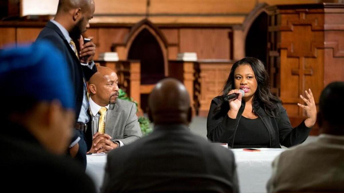 Mary-Pat Hector, right, with the National Action Network, speaks during a community town hall forum at Ebenezer Baptist Church, the church where The Rev. Martin Luther King Jr. preached, Monday, Dec. 8, 2014, in Atlanta.