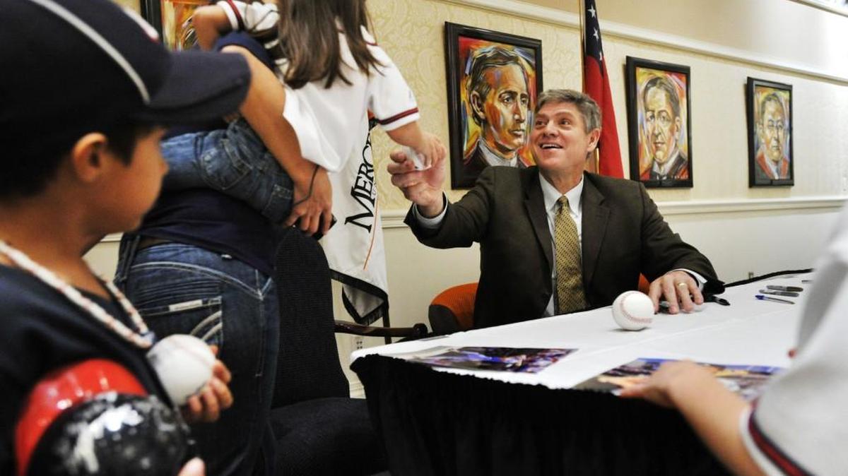 Atlanta Braves fan favorite Dale Murphy signs autographs at the Mercer University Center during part of the annual First Pitch Classic event in 2013.