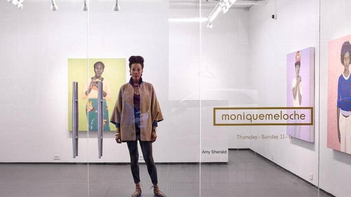 Amy Sherald, a Columbus native, has been selected by Former First Lady Michelle Obama to paint her official portrait for the Smithsonian’s National Portrait Gallery. In this photo, she stands in front of her painting “What’s different about Alice is that she has the most incisive way of telling the truth” at the Monique Meloche Gallery in Chicago.