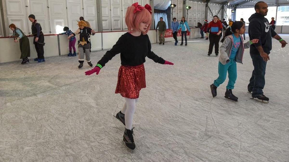 A young woman dressed in a cosplay costume ice skates at a rink in Centennial Park on Sunday, Dec. 7, 2014, in Atlanta.
