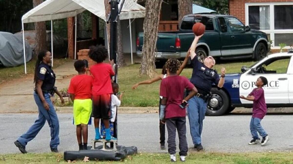 Officers Reeves and Henderson stopped to play some basketball with a group of kids in Oakland Park Sunday afternoon. Shanika Carter captured the moment happening in front of her house and said the experience made her 10-year-old son, Christian, think about officers in a more positive way.