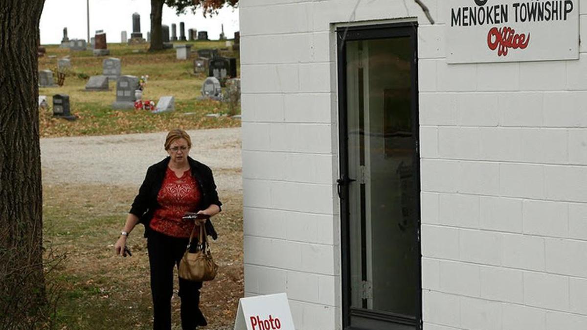 A voter walks to the Prairie Home Cemetery building to cast her ballot, Tuesday, Nov. 4, 2014, in Topeka, Kansas.