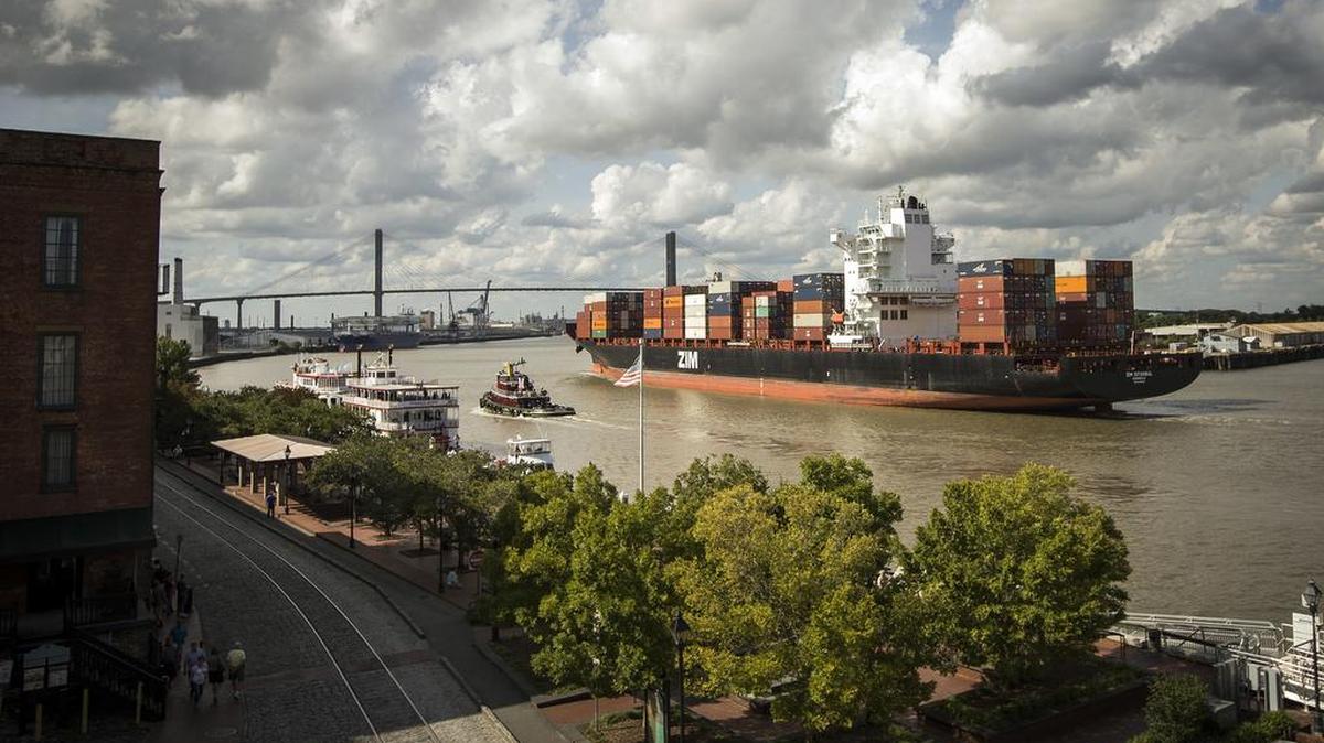 A container ship makes it’s way up the Savannah River past historic River Street in Savannah.