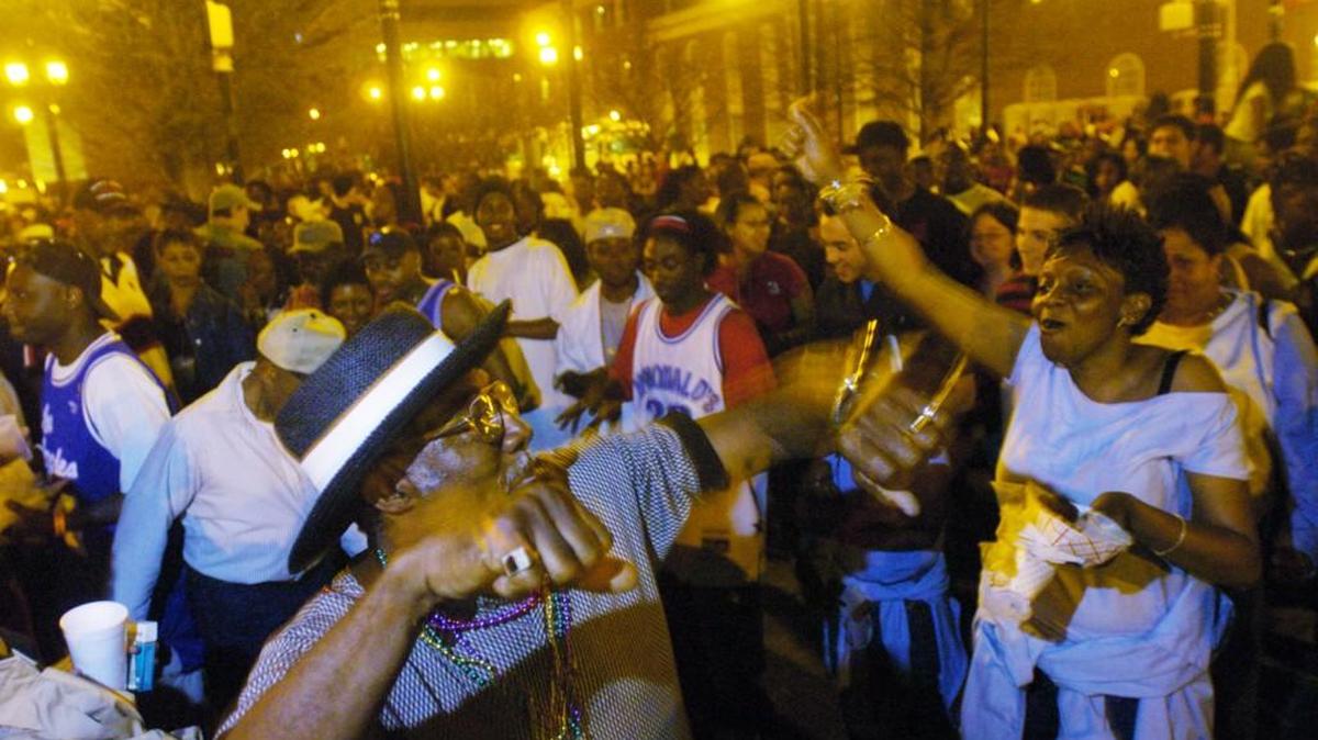 Andrew Mathis (L), of Fort Valley, dances with Monique Hubbard(R), of Milledgeville, during the Cherry Blossom Festival street party in Macon in 2005.