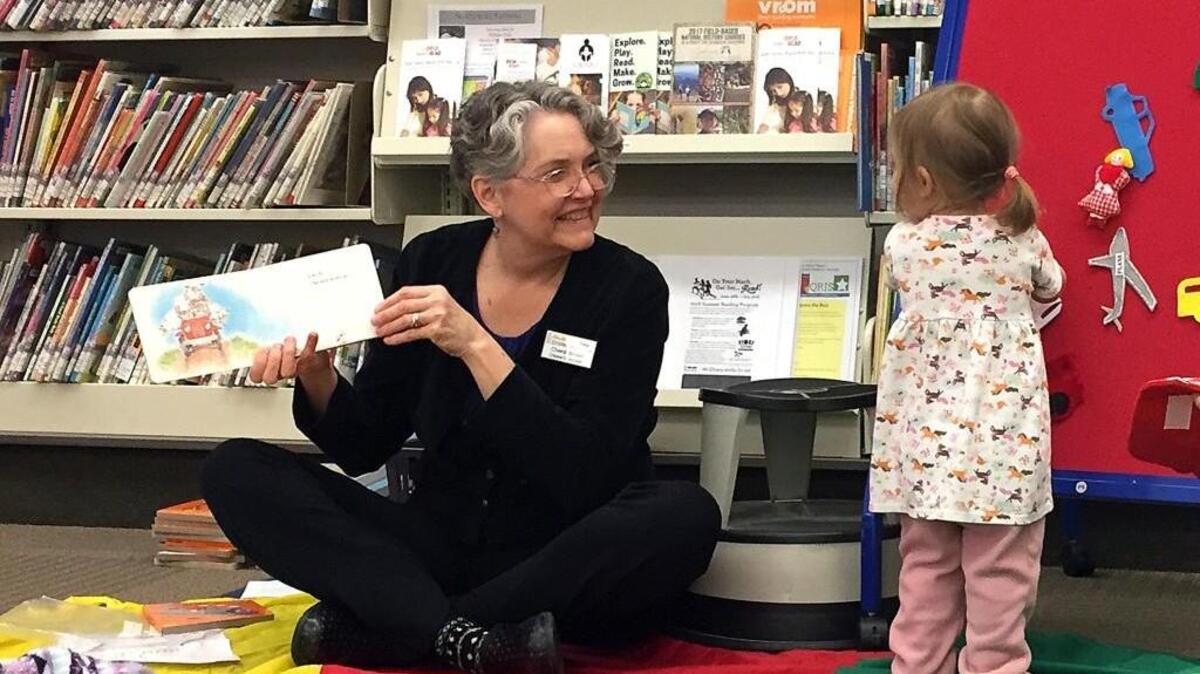 In this April 7, 2017, photo, children's librarian Chere Brown reads to toddlers during a story time.