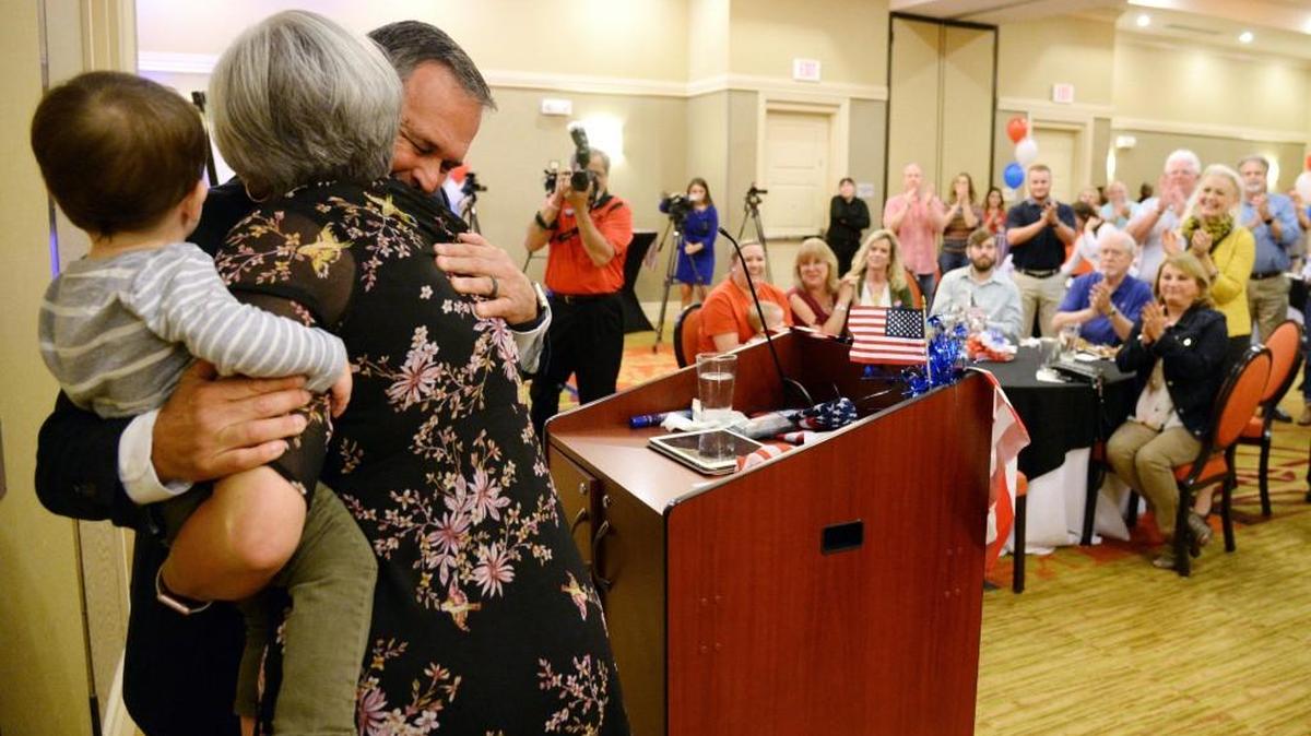 Warner Robins Mayor Randy Toms hugs his wife, Jane, after final results from Tuesday's election were announced at a campaign party.
