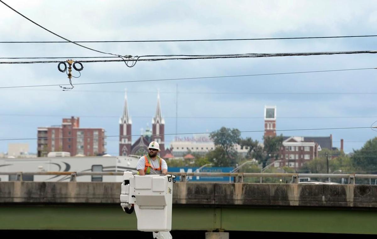 Macon-Bibb County employee Shannon Callaway installs a new light on Spring Street Tuesday afternoon where winds from Tropical Storm Irma knocked an old one down yesterday.