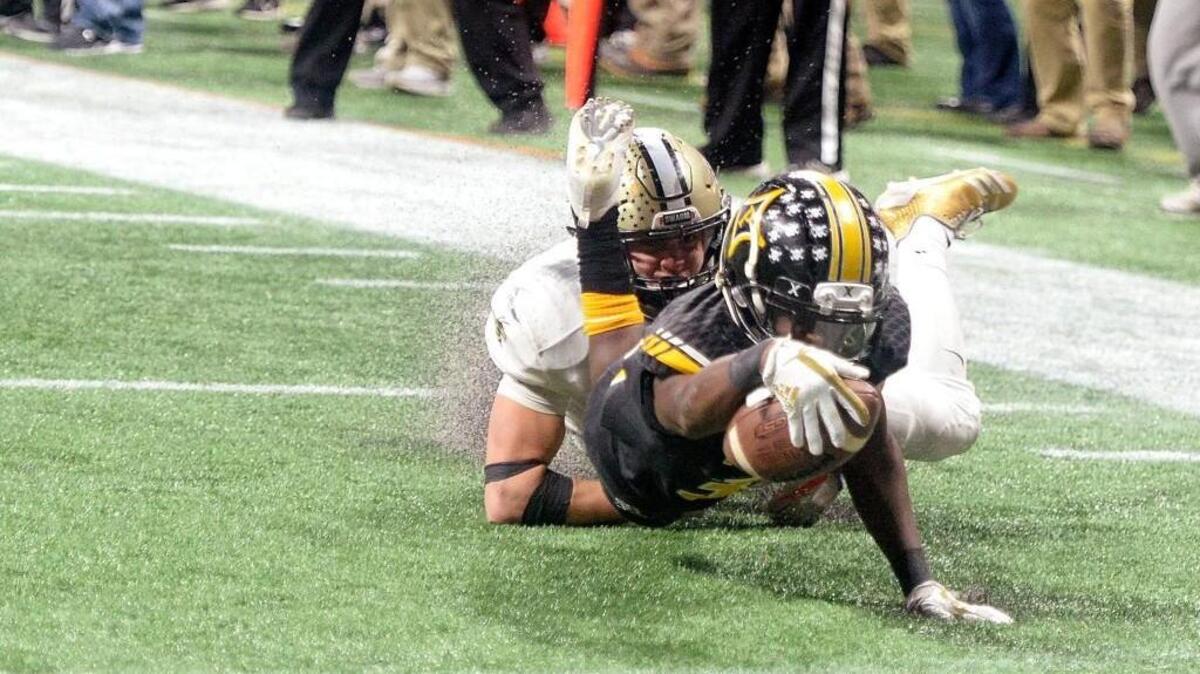 Peach County receiver Noah Whittington (35) stretches for the end zone after a fourth quarter reception against Calhoun in their GHSA State Championship game in Atlanta. An official called the catch incomplete and the Trojans eventually lost 10-6.
