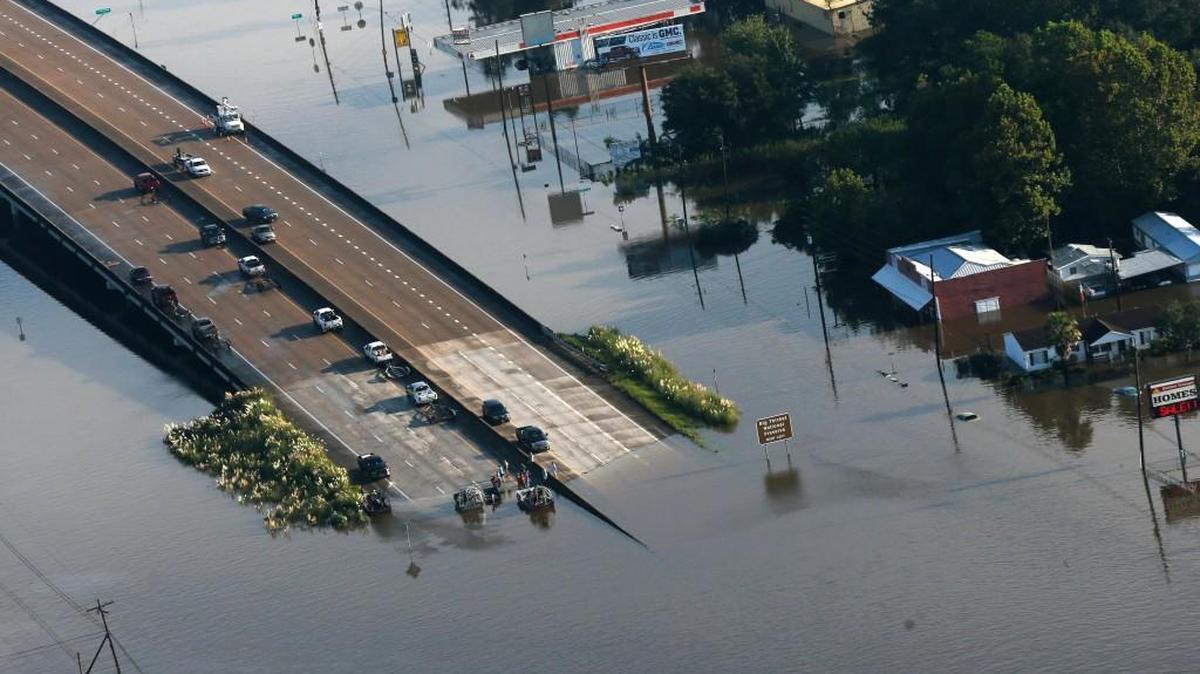 People launch boats from an overpass into floodwaters in the aftermath of Tropical Storm Harvey in Kountze, Texas, Thursday, Aug. 31, 2017.
