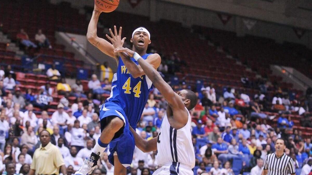 County's Lonnie Outlaw leaps past Whitefield Academy's Kris Redding during GHSA A Tournament play at the Macon Coliseum in 2016.