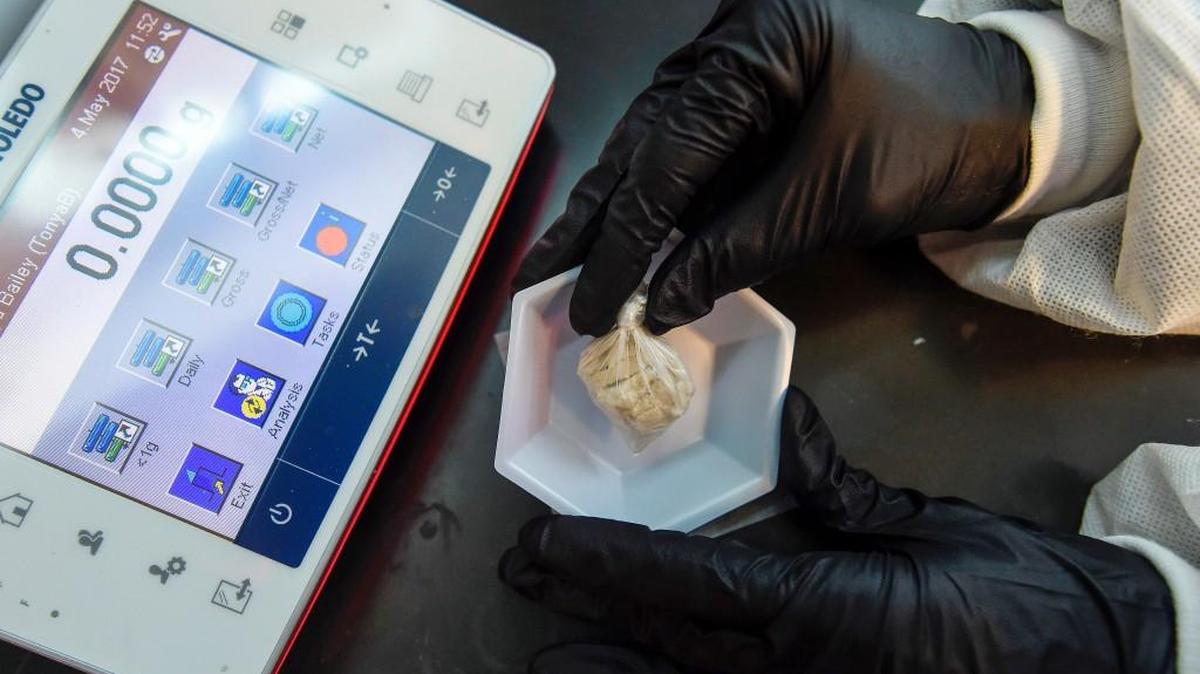 A forensic chemist prepares a sample of the drug "gray death" to be weighed at the crime lab of the Georgia Bureau of Investigations in Decatur, Ga., on Thursday, May 4, 2017. The new and dangerous opioid combo underscores the ever-changing nature of the U.S. addictions epidemic. Investigators who nicknamed the mixture have detected it or recorded overdoses blamed on it in Alabama, Georgia and Ohio.