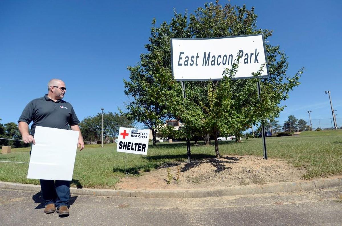 Red Cross Disaster Program Manager Rodney Miller says "It's official now" after planting a sign in front of the East Macon Park gym where his organization was setting up to provide shelter for those affected by Hurricane Irma Thursday.