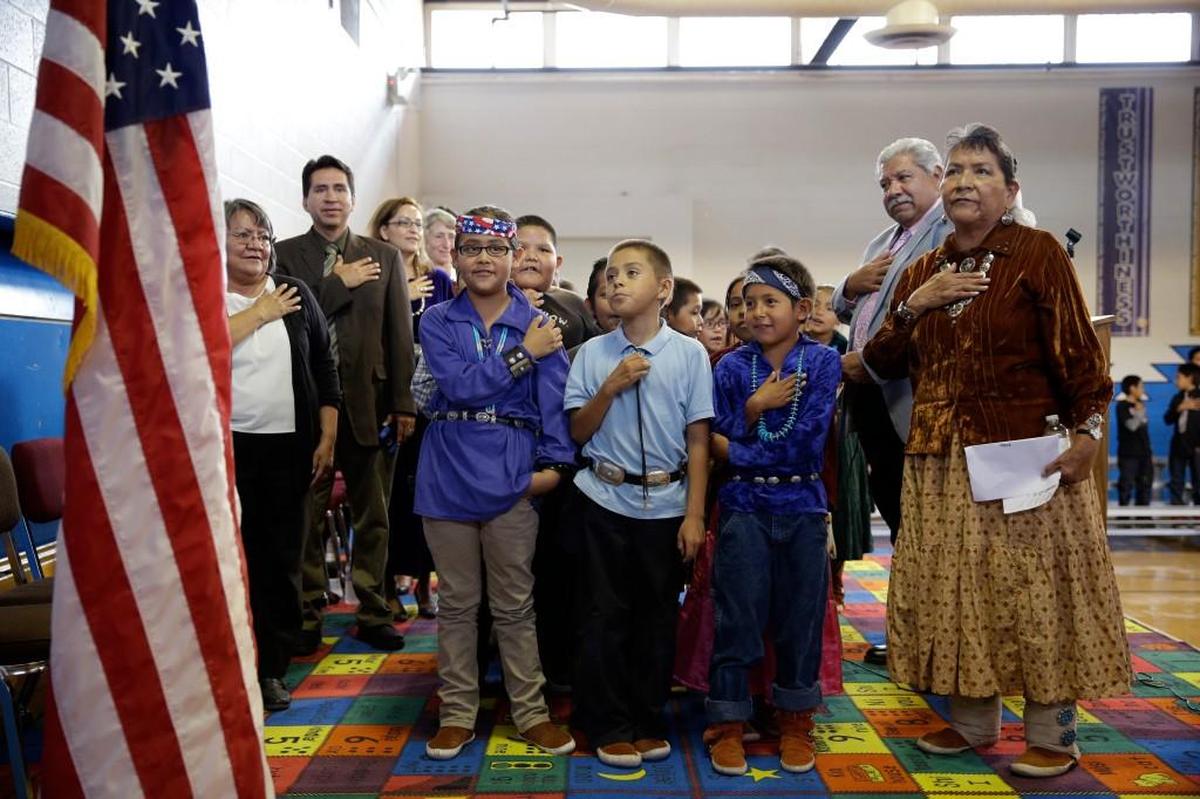 Students and faculty say the Pledge of Allegiance during an assembly at the Crystal Boarding School in Crystal, New Mexico on the Navajo Nation. The school is one of 183 for Native American students run by the Interior Department’s Bureau of Indian Education.