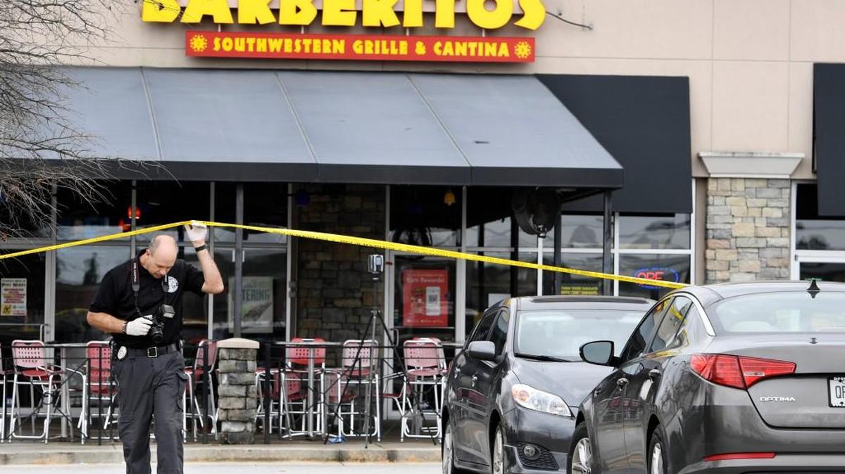 Crime scene investigators collect evidence in the parking lot of Barberitos at 3123 Watson Boulevard after a worker was killed and another injured in an armed robbery Sunday, Jan. 21, 2018. 
