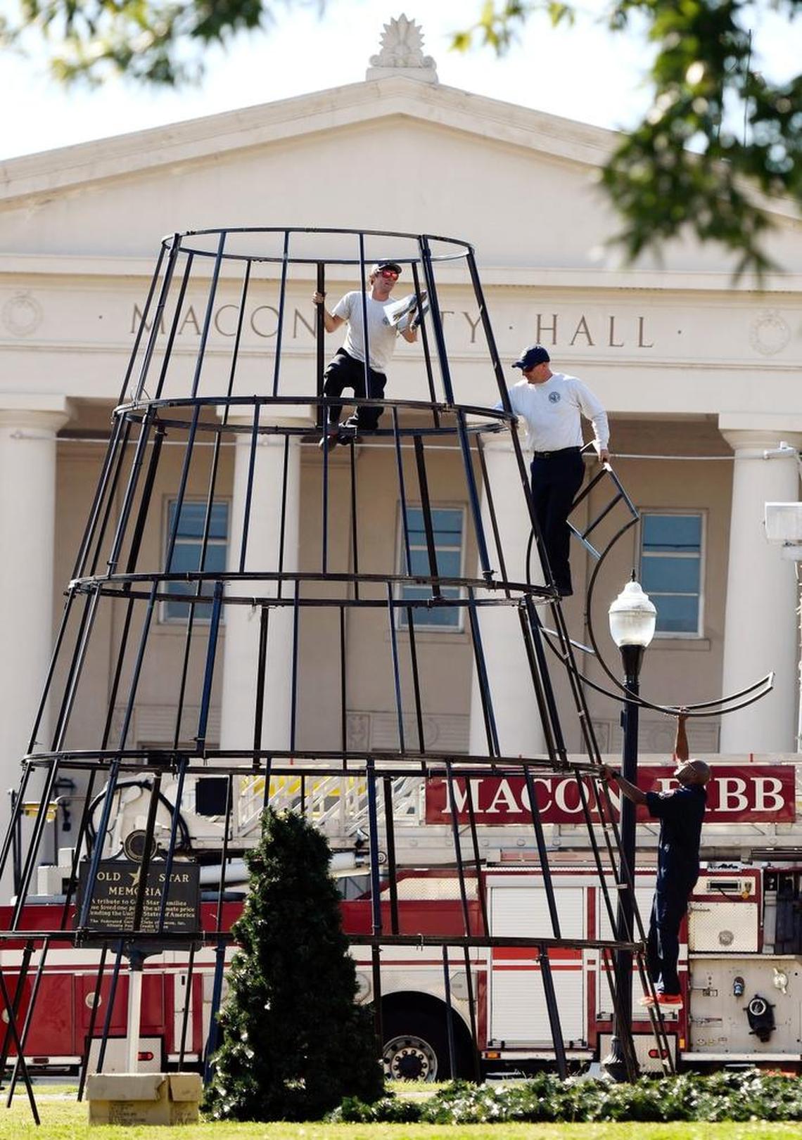 From left, Pvt. Cody McCallum, Sgt. Garin Flanders and Pvt. Matthew Cooper with the Macon-Bibb County Fire Department put together the frame of the large Christmas tree at Rosa Parks Square on Thursday. On Nov. 30, the Bibb County Board of Education will hold its annual Christmas tree lighting at 6:30 p.m. with students singing Christmas carols on the steps of the City Auditorium.