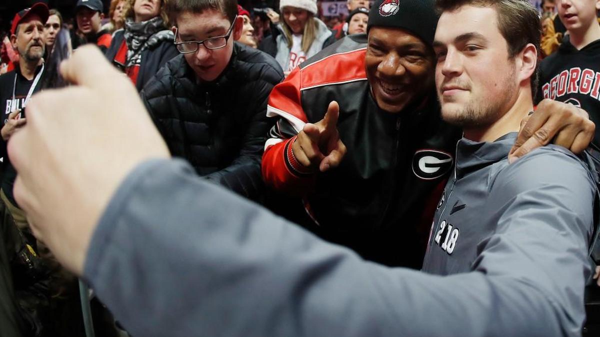 Georgia quarterback Jacob Eason takes a photo with a fan during media day, Saturday, Jan. 6, 2018, in Atlanta, where UGA played Alabama for the NCAA football national championship on Monday, Jan. 8.