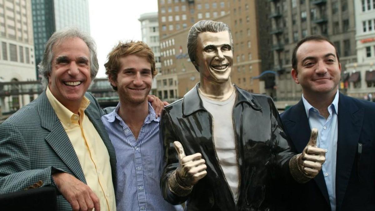 Actor Henry Winkler, left, poses with his sons Max Winkler, second left, and Jed Weitzman as they stand with a bronze statue of the "Happy Days" character Arthur Fonzarelli, also known as "The Fonz," at an unveiling, Tuesday, Aug. 19, 2008, in Milwaukee. The program, which ran from 1974-1984, was based in Milwaukee.