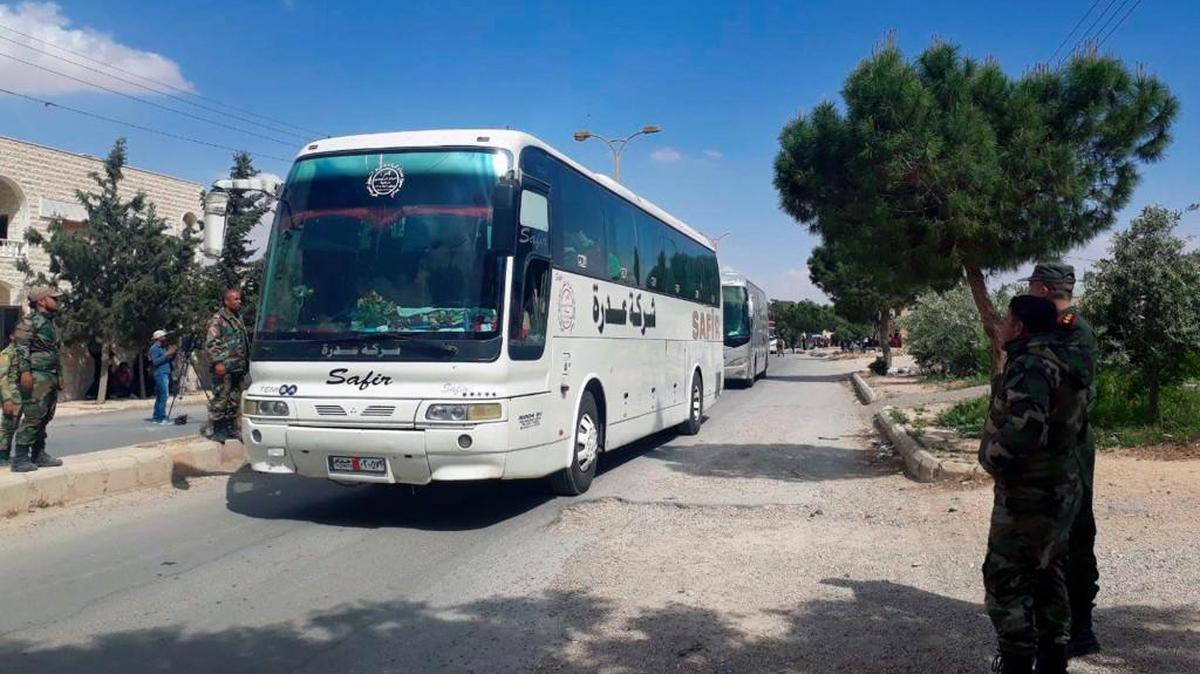 This photo released by the Syrian official news agency SANA, shows Syrian government forces overseeing the evacuation by bus of rebels and their family from the towns of Ruhaiba in the eastern Qalamoun region in the Damascus countryside on Saturday.